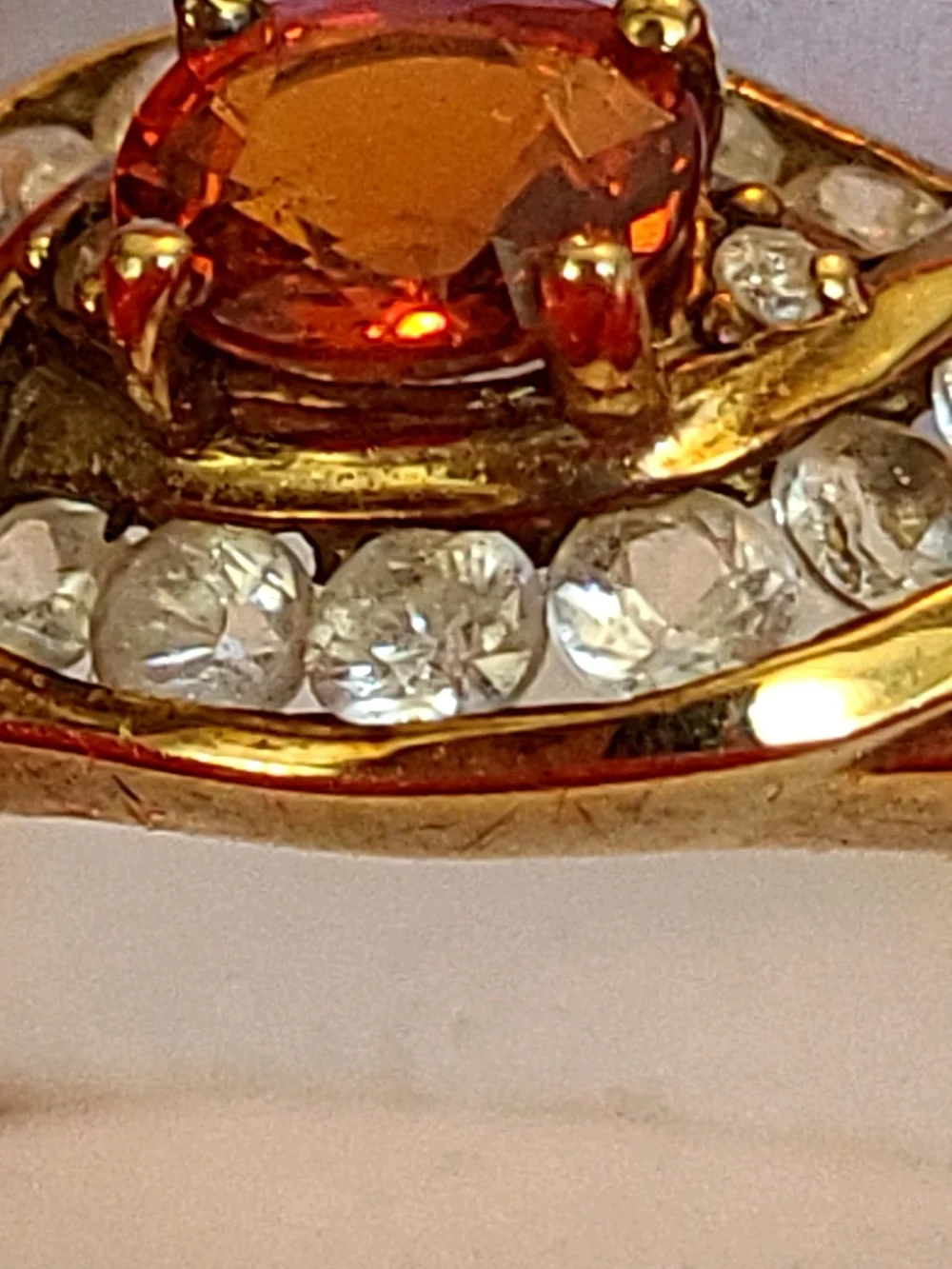 1.25ct. Spessartite Garnet Surrounded By 14 Sparkling Diamonds!